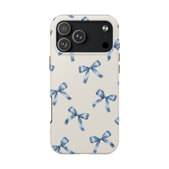 Sunday Theory protective phone case with a cream background and watercolor blue ribbon bow pattern, glossy finish.