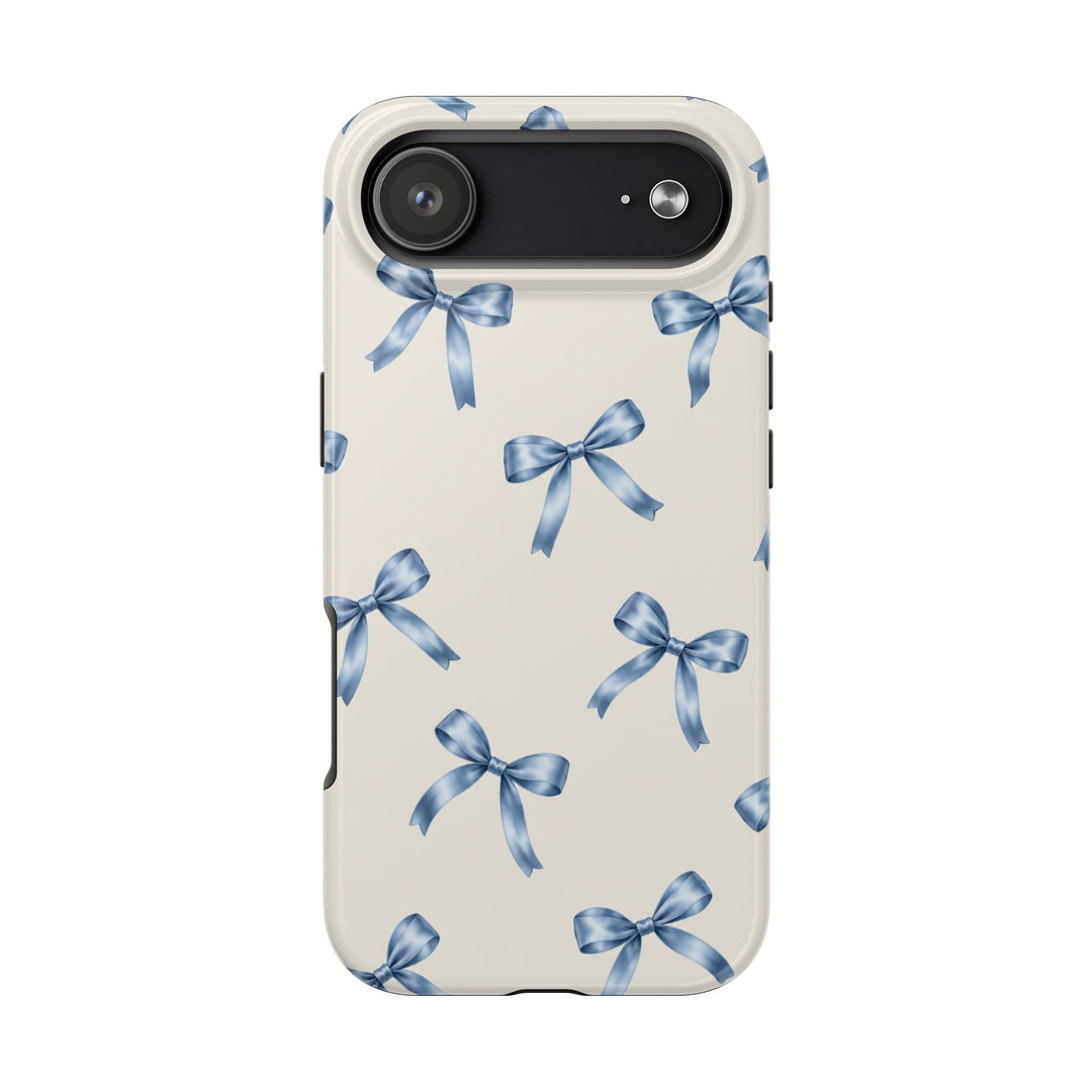 Sunday Theory protective phone case with a cream background and a delicate watercolor blue bow pattern, glossy finish.