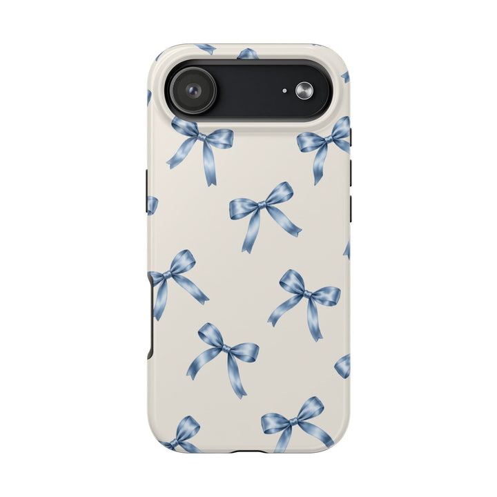Sunday Theory protective phone case with a cream background and a delicate watercolor blue bow pattern, glossy finish.
