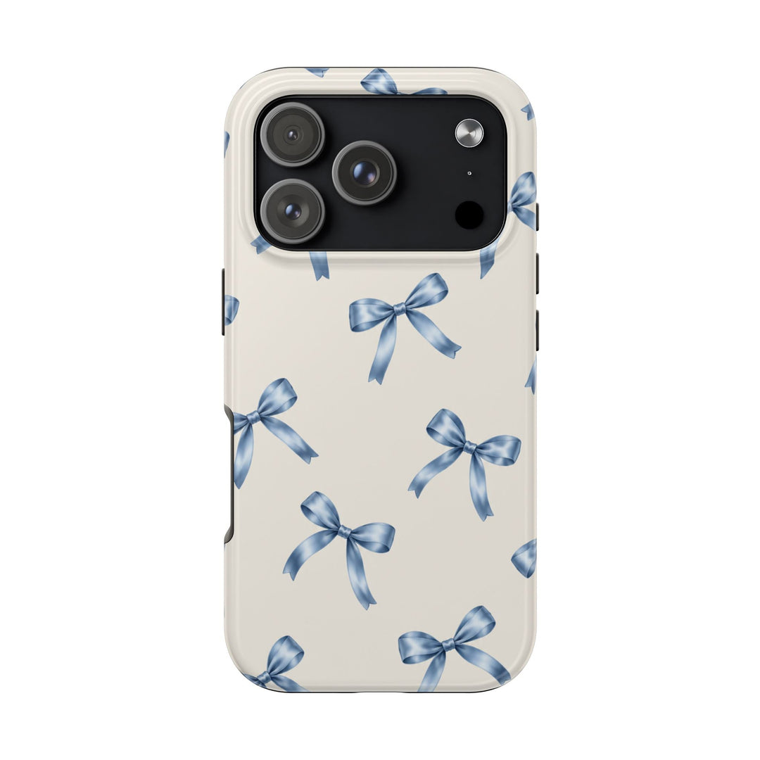Sunday Theory protective phone case with a cream background and watercolor blue ribbon bow pattern, glossy finish.