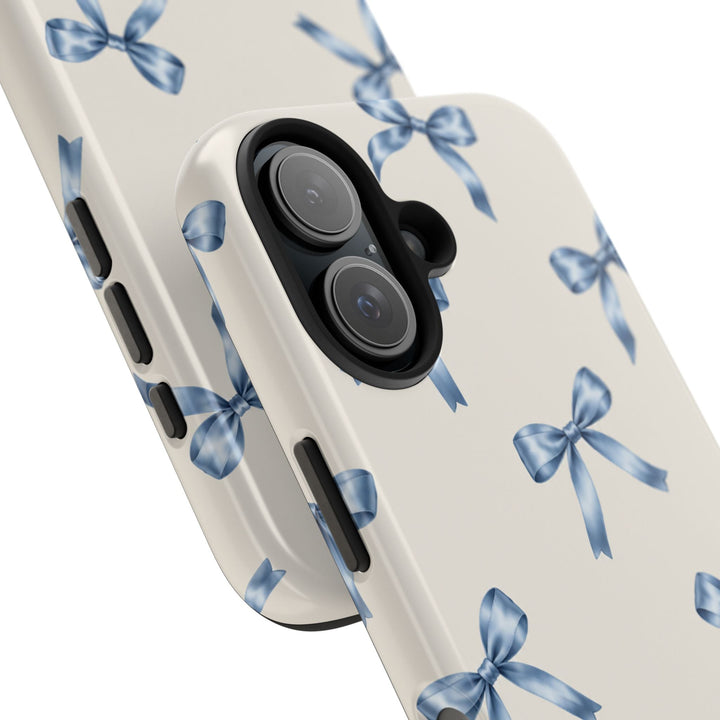 Sunday Theory protective phone case with cream background and watercolor blue bow pattern, featuring a glossy finish.