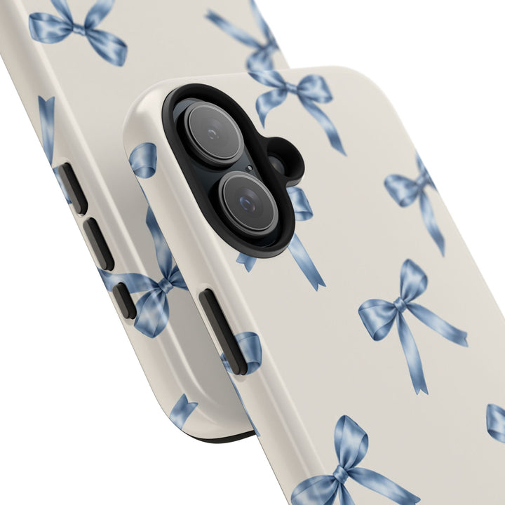 Sunday Theory protective phone case with a cream background and watercolor blue bow pattern, glossy finish.