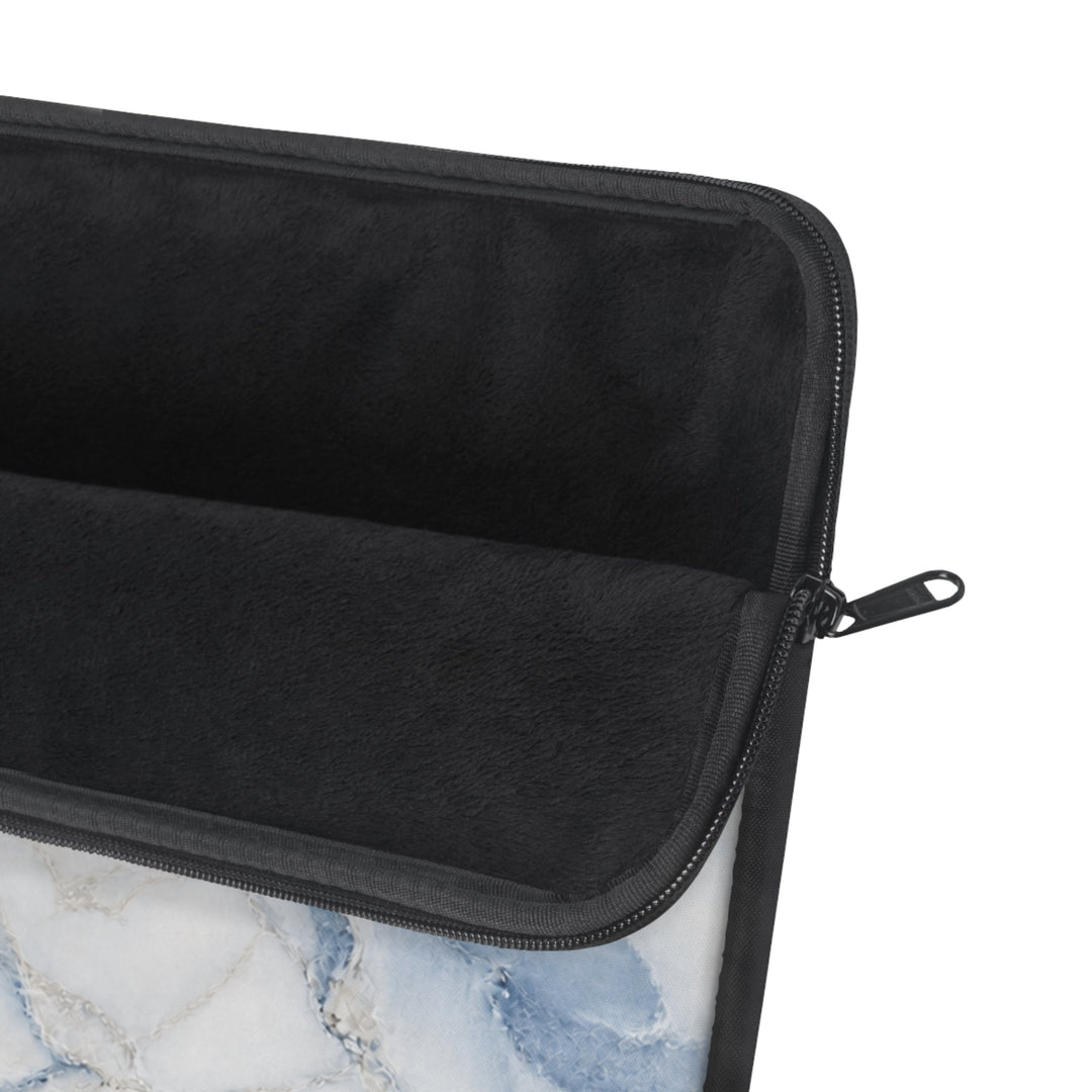 Sunday Theory blue marble laptop sleeve with a plush black fleece interior and smooth zipper closure.