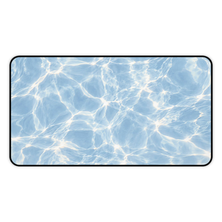 Sunday Theory Blue Hour desk mat with a shimmering blue pool water surface design and durable hemmed edges.