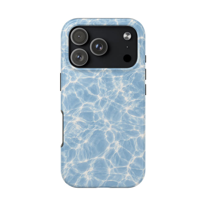 Sunday Theory phone case with a blue shimmering water reflection pattern, featuring a durable glossy finish.