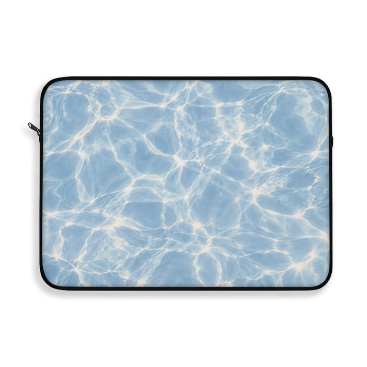 Sunday Theory blue laptop sleeve featuring a sunlit water ripple print, plush fleece interior, and black trim.