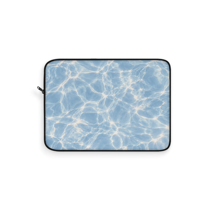 Sunday Theory blue laptop sleeve featuring a sunlit water ripple print, foam padding, and a durable polyester exterior.