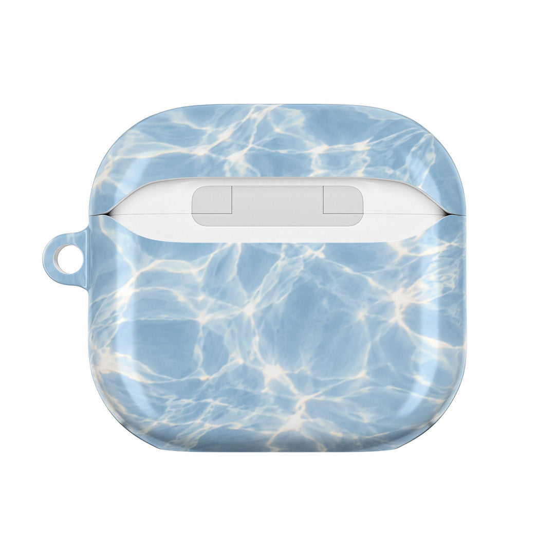 Sunday Theory glossy blue water ripple pattern polycarbonate protective case for AirPods with a side carabiner loop.