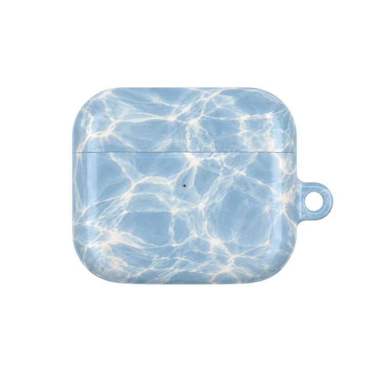 Sunday Theory blue water ripple patterned polycarbonate AirPod case with a glossy finish and side carabiner loop.