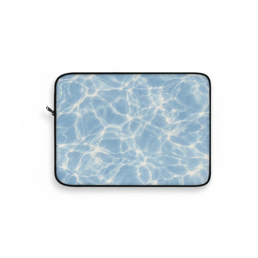 Sunday Theory blue laptop sleeve featuring a sunlit water ripple print, plush fleece interior, and protective foam.