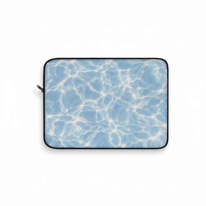Sunday Theory blue laptop sleeve featuring a sunlit water ripple print, plush fleece interior, and protective foam.