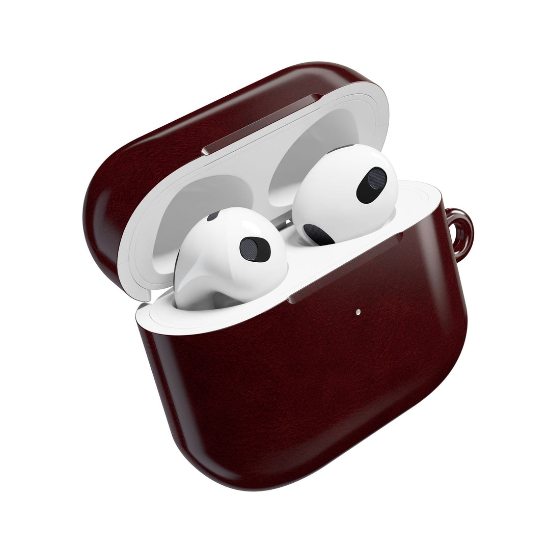 Sunday Theory burgundy glossy polycarbonate AirPod case with white earbuds inside and a side attachment loop