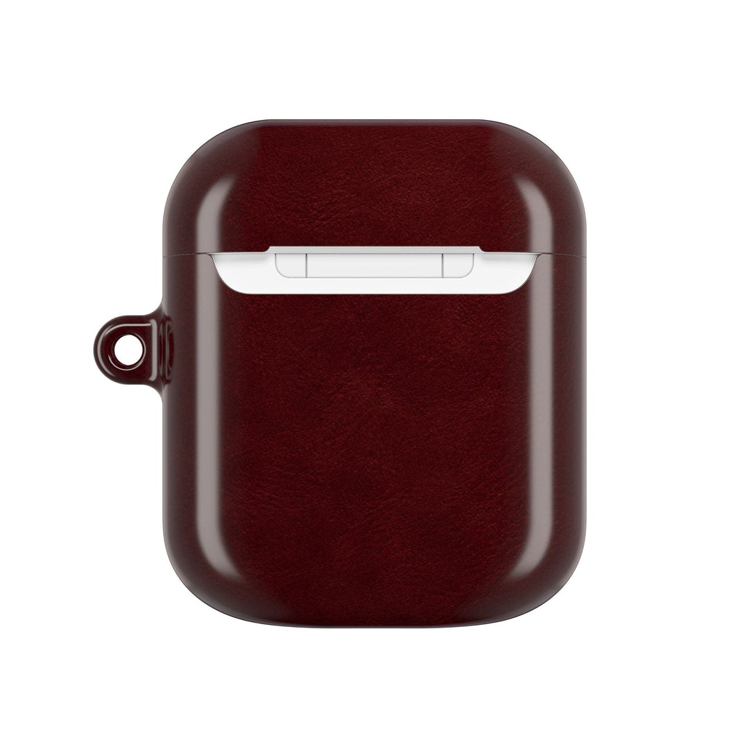 Sunday Theory burgundy glossy polycarbonate AirPod case with a built-in keyring loop for secure attachment.