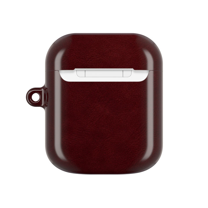 Sunday Theory burgundy glossy polycarbonate AirPod case with a built-in keyring loop for secure attachment.
