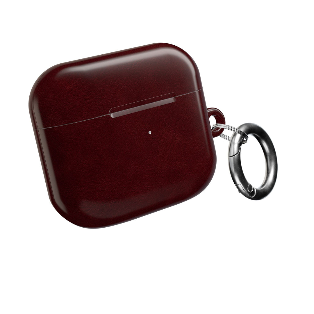 Sunday Theory burgundy glossy polycarbonate AirPod case with a silver carabiner for secure attachment