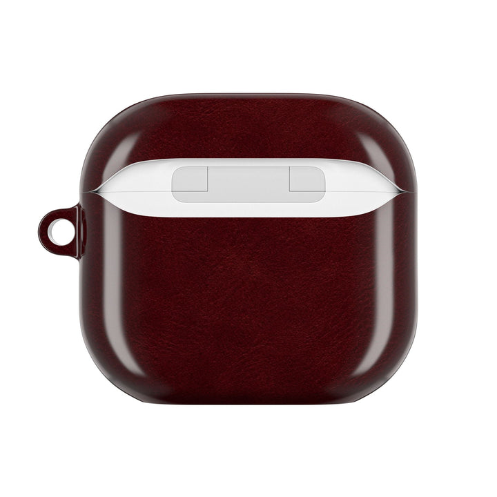 Sunday Theory burgundy glossy polycarbonate AirPod case with a slim protective shell and integrated keyring loop