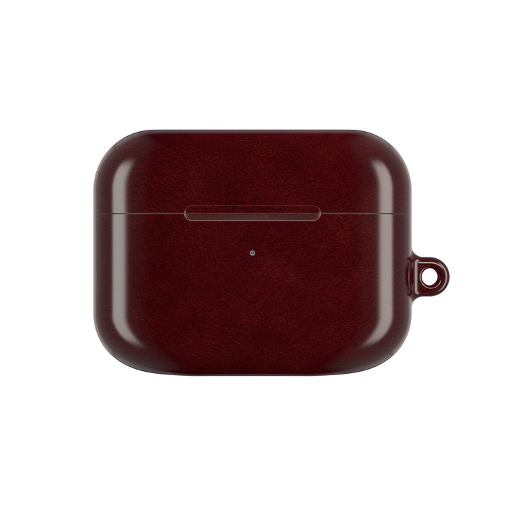 Sunday Theory burgundy glossy polycarbonate AirPod case with a side attachment loop for a carabiner