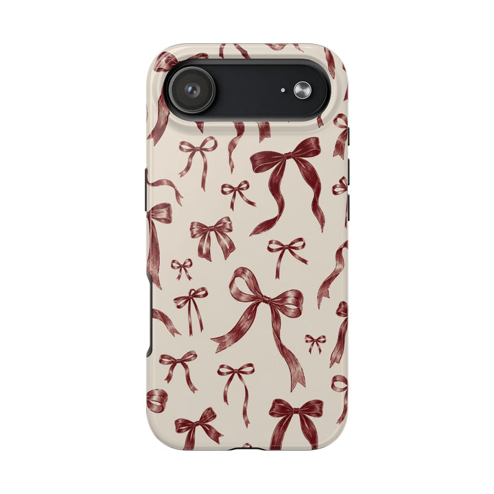 Sunday Theory tough phone case with a vintage burgundy bow print on a cream background and a glossy finish.