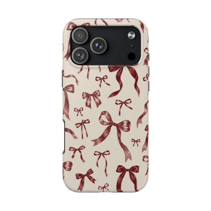 Sunday Theory protective phone case with a vintage burgundy bow print on a cream background and glossy finish.