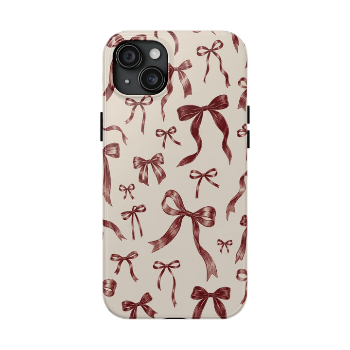 Sunday Theory protective phone case with a vintage burgundy bow pattern on a cream background and glossy finish.