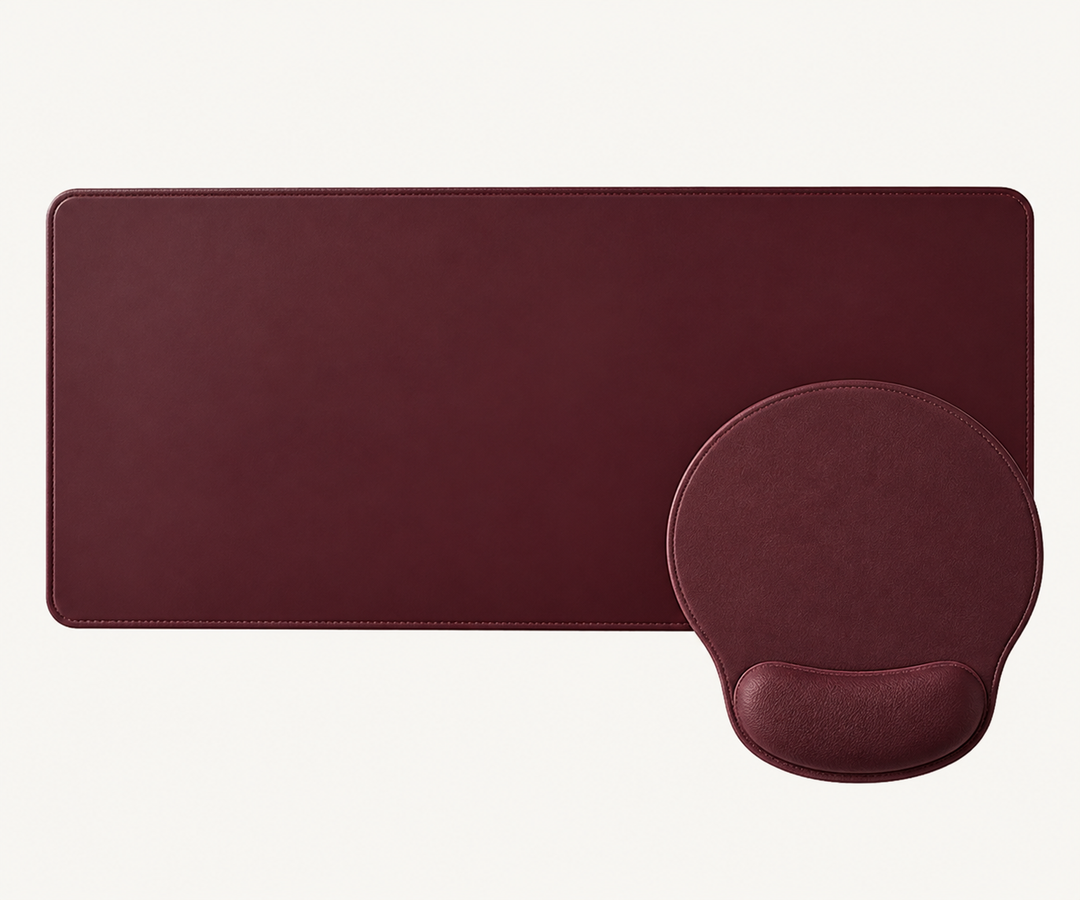Sunday Theory burgundy leather-look desk mat and ergonomic mouse pad with memory foam wrist rest on white background.