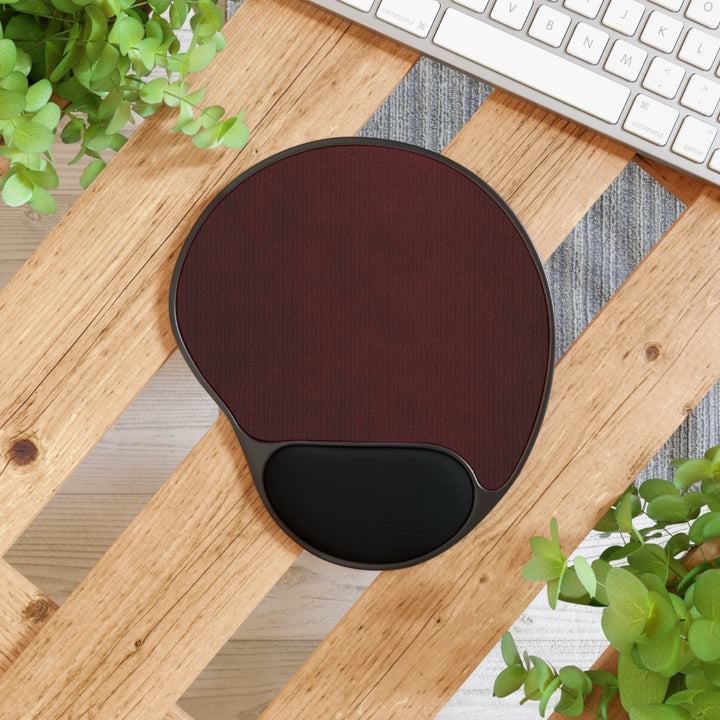 Sunday Theory burgundy ergonomic mouse pad with black memory foam wrist rest on a wooden desk surface