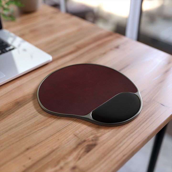Sunday Theory burgundy ergonomic mouse pad with black memory foam wrist rest on a wooden desk