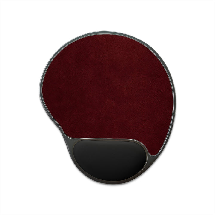 Sunday Theory ergonomic burgundy leatherette mouse pad with a black memory foam wrist rest on a foot-shaped base.