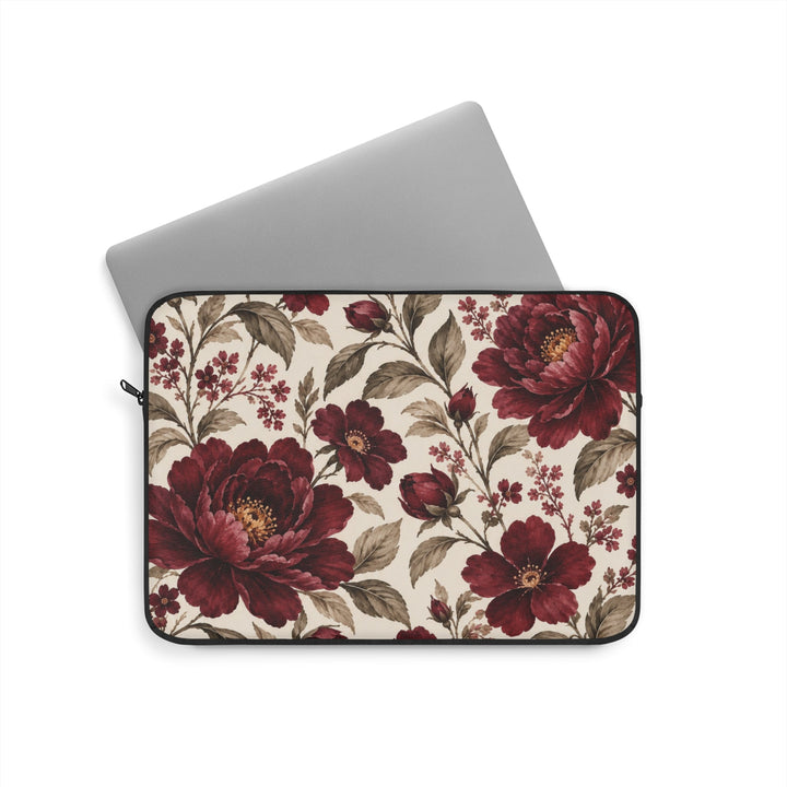 Sunday Theory laptop sleeve featuring a vintage burgundy peony floral print on a cream background with a laptop inside