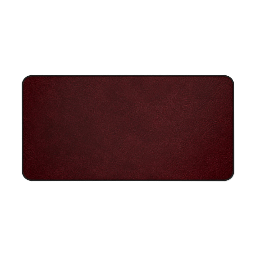 Sunday Theory burgundy leather-look desk mat with a smooth texture and black stitched edges.