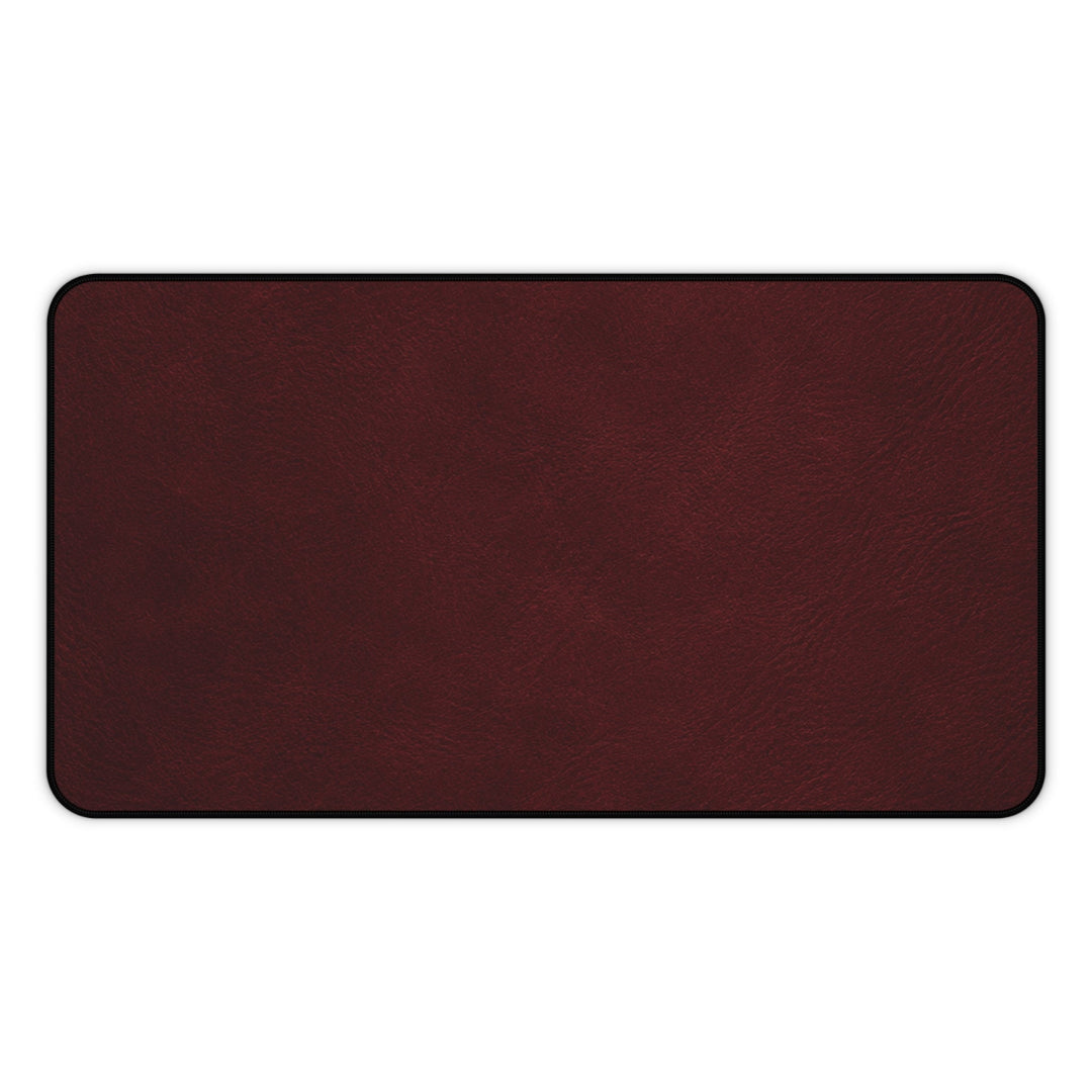 Sunday Theory burgundy neoprene desk mat with a smooth leather-look surface and durable hemmed edges.