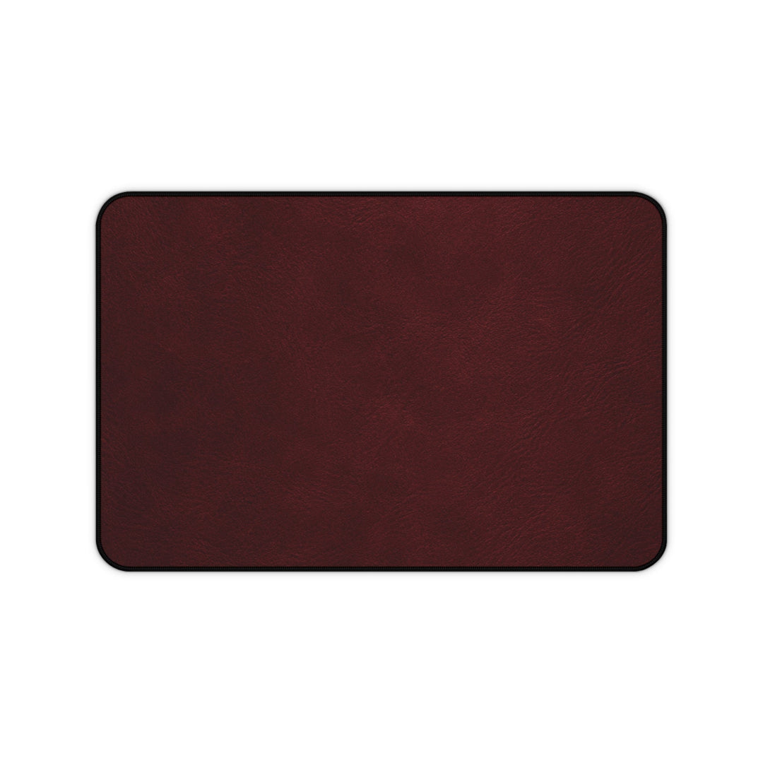 Sunday Theory burgundy leather-look neoprene desk mat with hemmed edges and anti-slip backing for office workspaces.