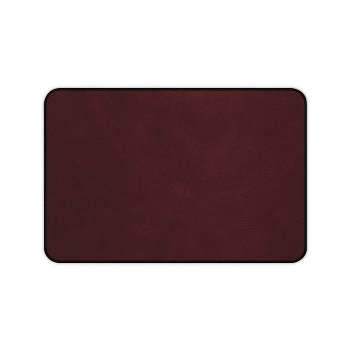 Sunday Theory burgundy leather-look neoprene desk mat with hemmed edges and anti-slip backing for office workspaces.