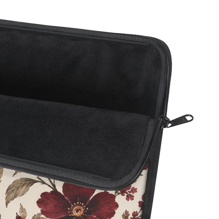Sunday Theory laptop sleeve with burgundy peony floral print, cream background, and plush black fleece interior.