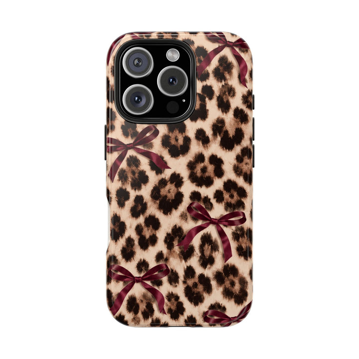 Sunday Theory leopard print phone case with burgundy bows, featuring a glossy, impact-resistant protective shell.