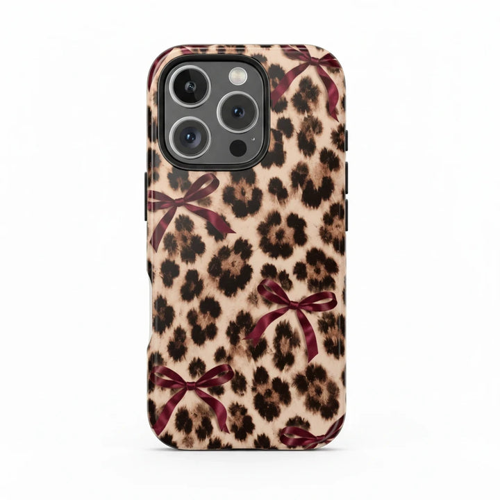 Sunday Theory leopard print phone case with burgundy bows, featuring a glossy, impact-resistant protective shell.