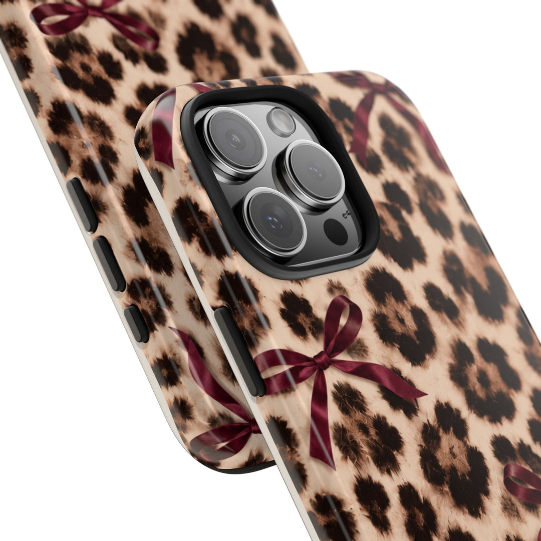 Sunday Theory leopard print phone case with burgundy bows, featuring a glossy finish and protective TPU liner.