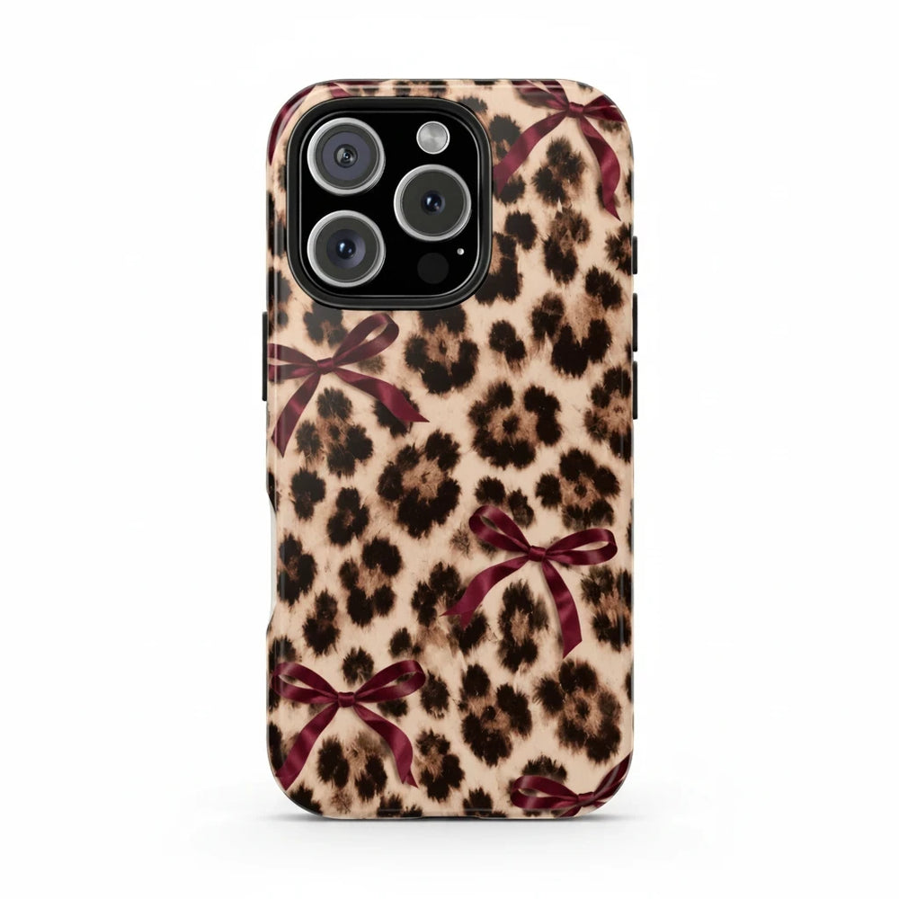 Sunday Theory leopard print phone case with burgundy bows, featuring a glossy, impact-resistant protective shell.