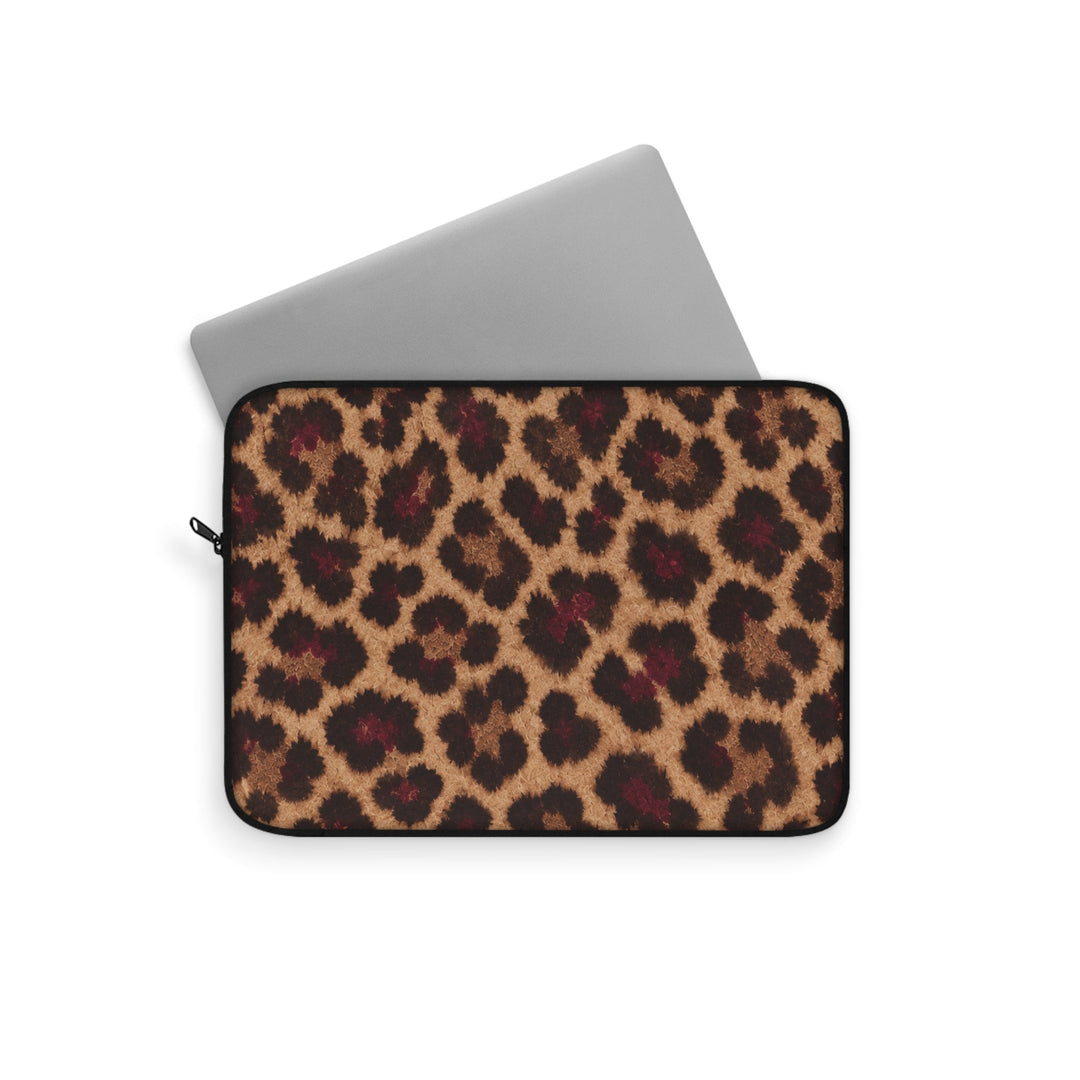 Sunday Theory leopard print laptop sleeve with a silver laptop partially inserted, featuring a plush fleece interior.