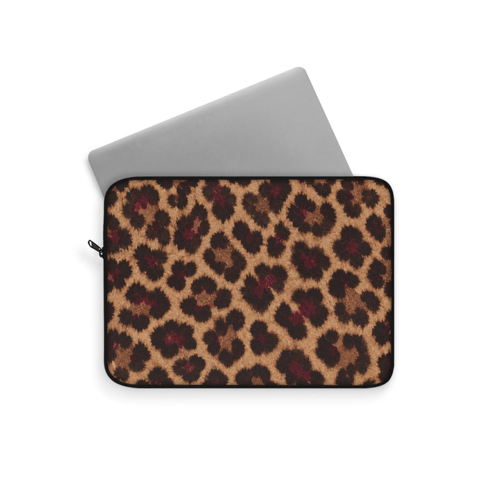 Sunday Theory leopard print laptop sleeve with a silver laptop partially inserted, featuring a plush fleece interior.