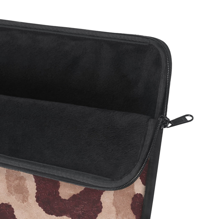 Sunday Theory leopard print laptop sleeve with a plush black fleece interior and durable metal zipper closure.