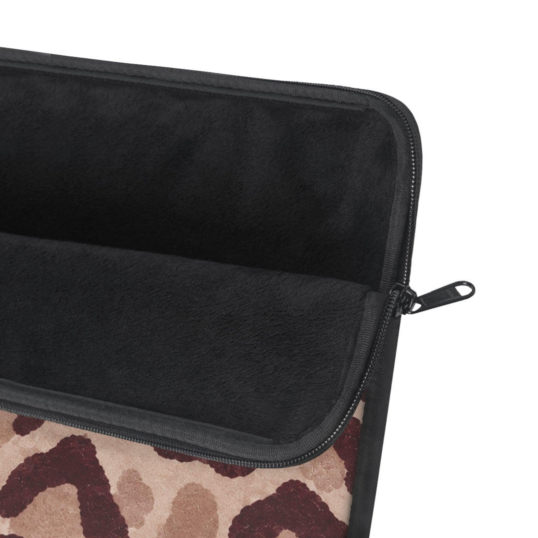 Sunday Theory leopard print laptop sleeve featuring a plush black fleece interior and a durable metal zipper.