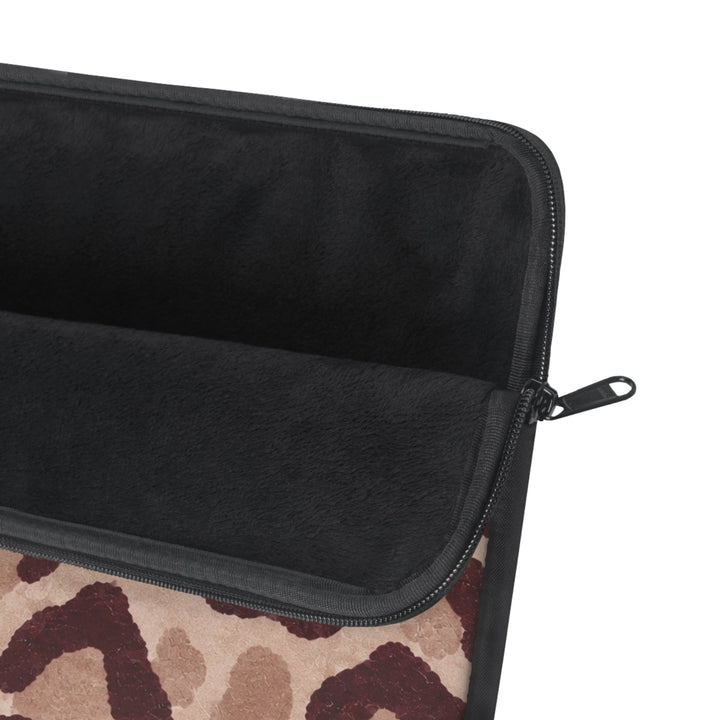 Sunday Theory leopard print laptop sleeve featuring a plush black fleece interior and a durable metal zipper.