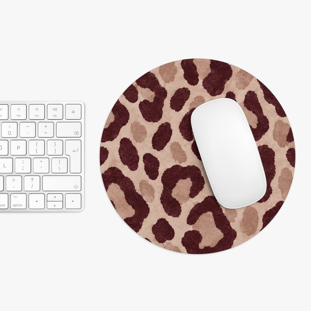 Sunday Theory round neoprene mouse pad with a brown leopard print pattern next to a white computer mouse and keyboard