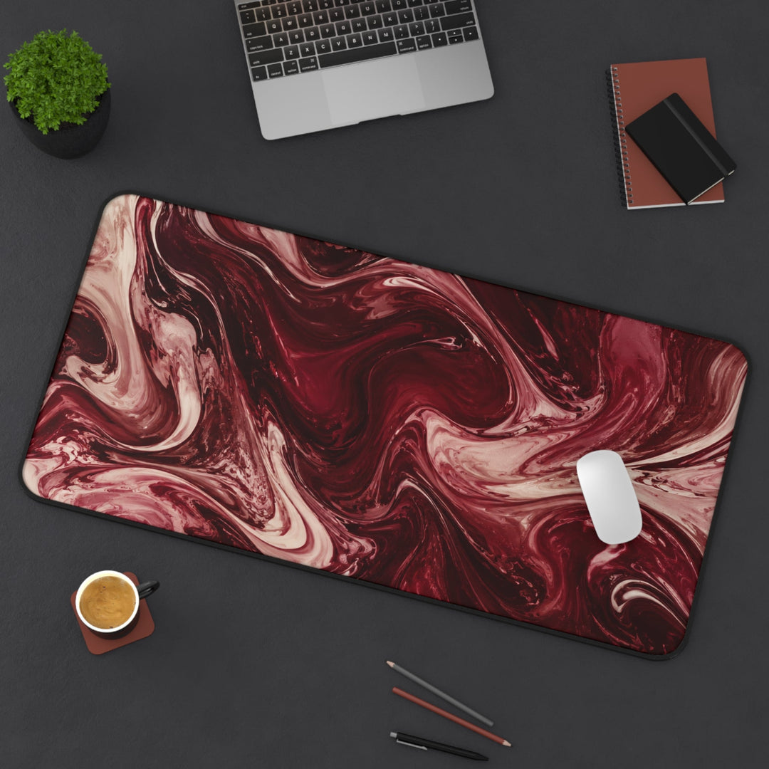 Sunday Theory maroon marble desk mat and ergonomic mouse pad set on a dark desk with laptop and coffee