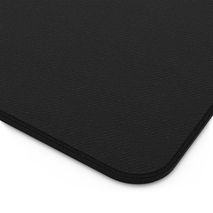 Sunday Theory maroon marble desk mat with a textured black non-slip neoprene surface and reinforced hemmed edges.