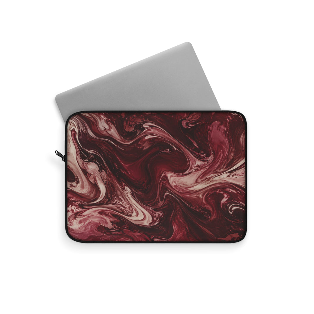 Sunday Theory maroon and cream marble swirl laptop sleeve with a silver laptop partially inserted.