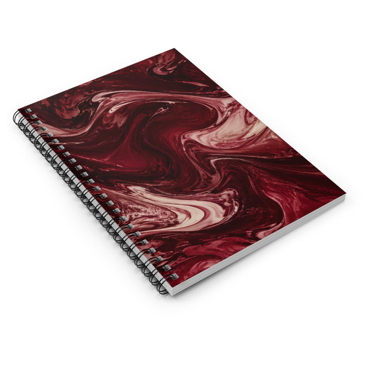 Sunday Theory maroon marble spiral notebook with burgundy and cream swirls and metal binding on a white background.