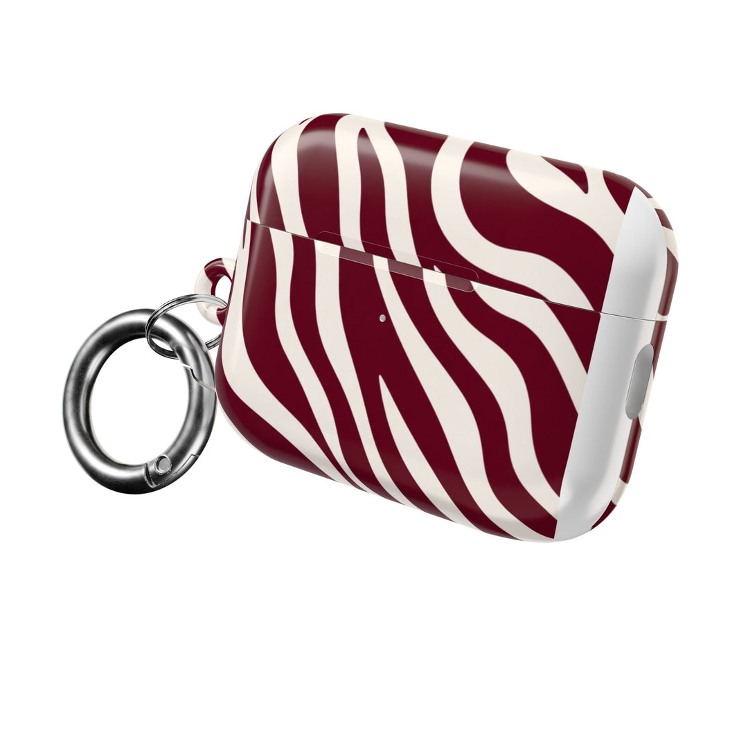 Sunday Theory maroon and cream zebra stripe glossy polycarbonate AirPod case with a silver carabiner attachment.