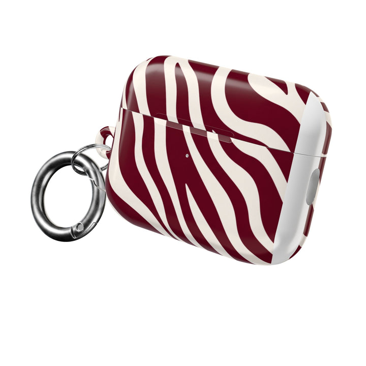Sunday Theory maroon and cream zebra stripe glossy polycarbonate AirPod case with a silver carabiner attachment.